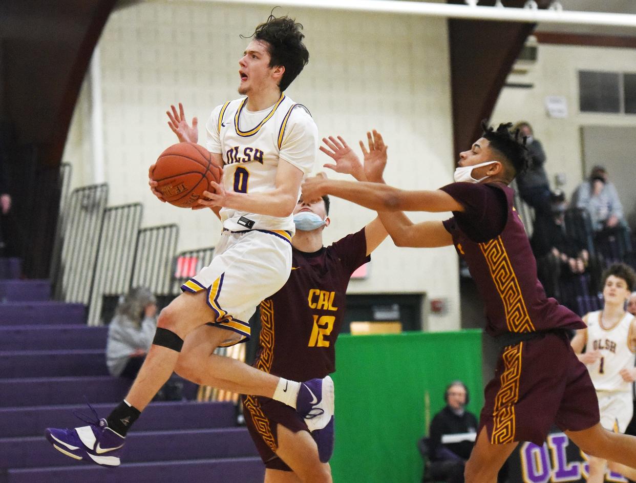 OLSH's Jake DiMichele jumps around California defenders for a layup during a WPIAL Class 2A playoff game on Wednesday, March 3, 2021, at Our Lady of the Sacred Heart High School.