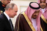 FILE PHOTO: Russian President Vladimir Putin and Saudi Arabia's King Salman attend a welcome ceremony in Riyadh