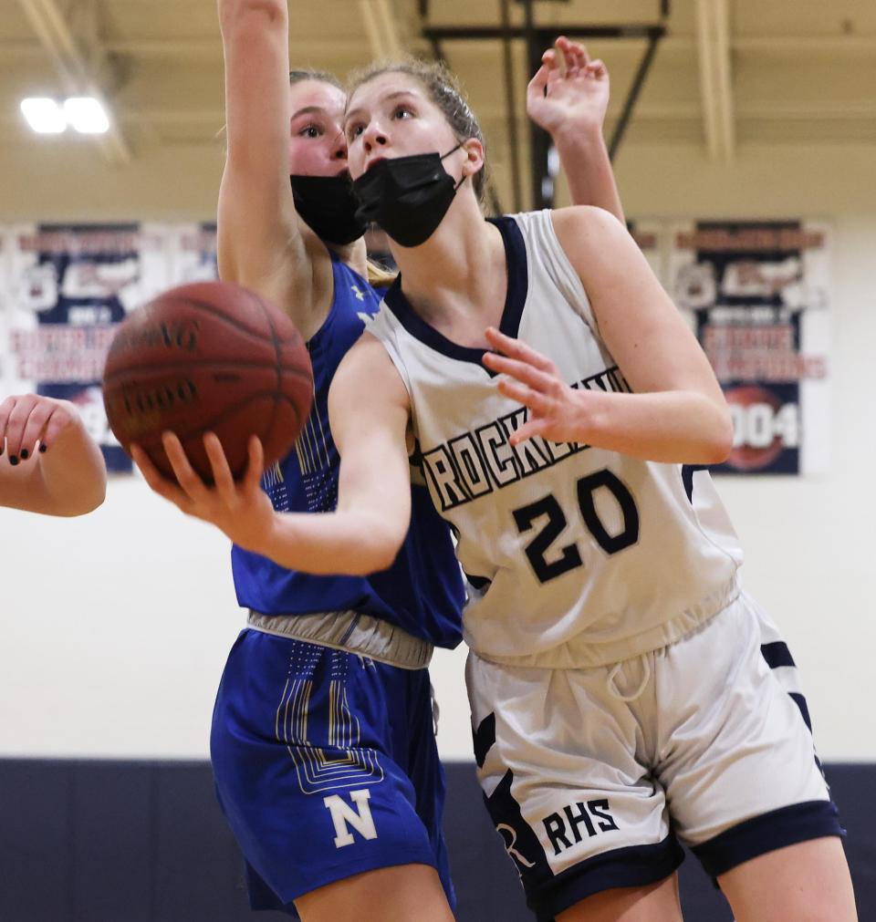 Rockland's Julie Elie takes a shot next to Norwell defender Grace Oliver during a game on Tuesday, Jan. 25, 2022.  