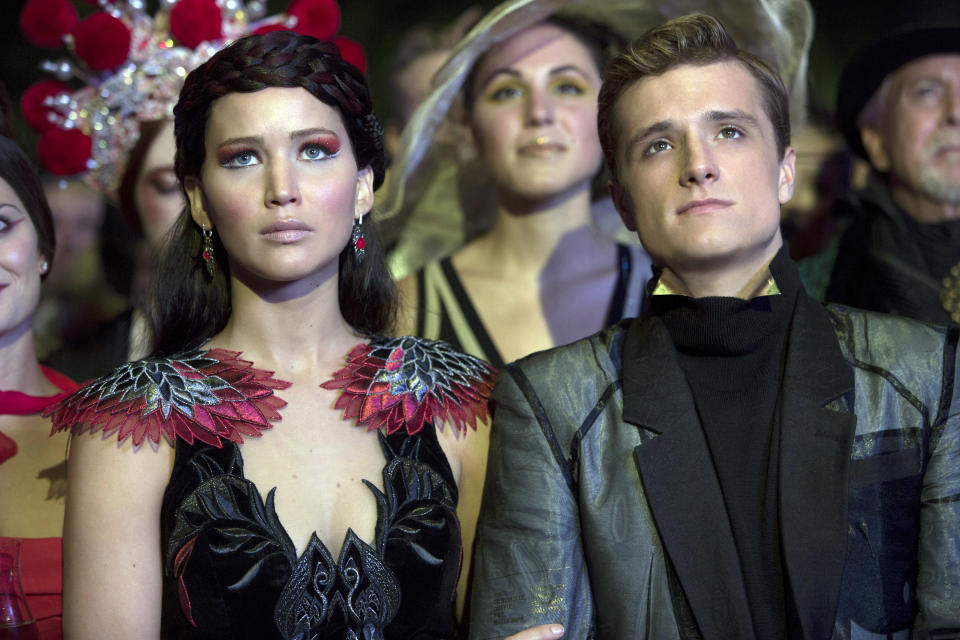 Katniss and Peeta sitting next to each other in a scene from "Catching Fire"