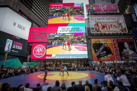 U.S. wrestler Tervel Dlagnev wrestles Andres Ramos Dinza of Cuba during the "Salsa in the Square" wrestling match in New York's Times Square, May 21, 2015. REUTERS/Brendan McDermid