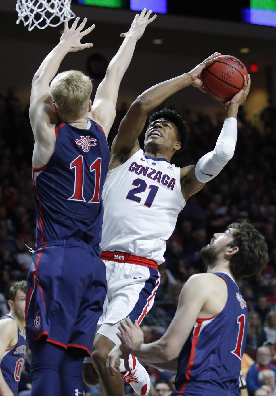 Gonzaga's Rui Hachimura shoots around St. Mary's Matthias Tass, left, and St. Mary's Jordan Hunter during the first half of an NCAA college basketball game for the West Coast Conference men's tournament title, Tuesday, March 12, 2019, in Las Vegas. (AP Photo/John Locher)