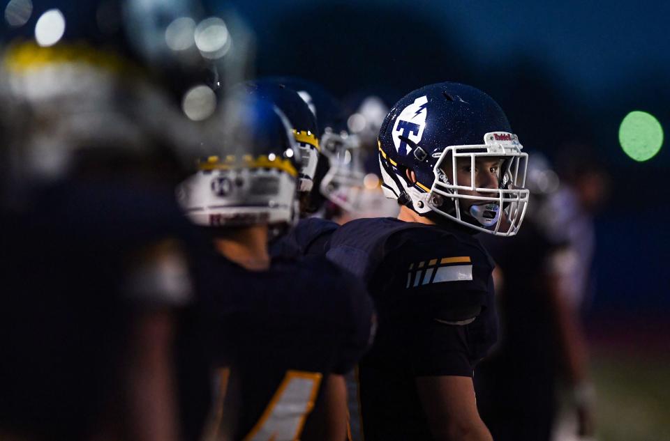 A Tea Area player looks past his teammates on the sideline during in a football game on Friday, September 9, 2022, in Tea.