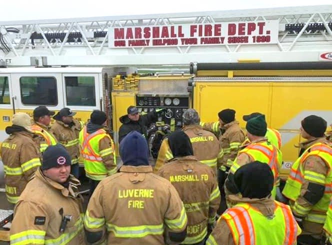 Lt. Chris Noeldner instructs the Luverne and Marshall, Minn., firefighters on how to run the fire engine.