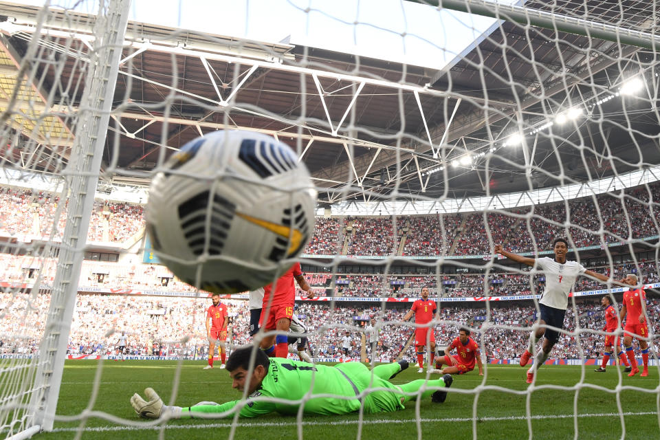 <p>LONDON, ENGLAND - SEPTEMBER 05: Jude Bellingham of England celebrates as Josep Gomes of Andorra fails to save as Jesse Lingard of England scores their team's first goal during the 2022 FIFA World Cup Qualifier match between England and Andorra at Wembley Stadium on September 05, 2021 in London, England. (Photo by Shaun Botterill/Getty Images)</p>
