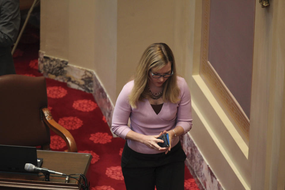 Minnesota state Sen. Nicole Mitchell, a Democrat from Woodbury who faces an ethics hearing Tuesday stemming from her arrest on a felony burglary charge, gets up to leave from her desk on the Senate floor in the State Capitol in St. Paul, on Monday, May 6, 2024. Mitchell told police she broke in last month because her stepmother refused to give her items of sentimental value from her late father. (AP Photo/Steve Karnowski)