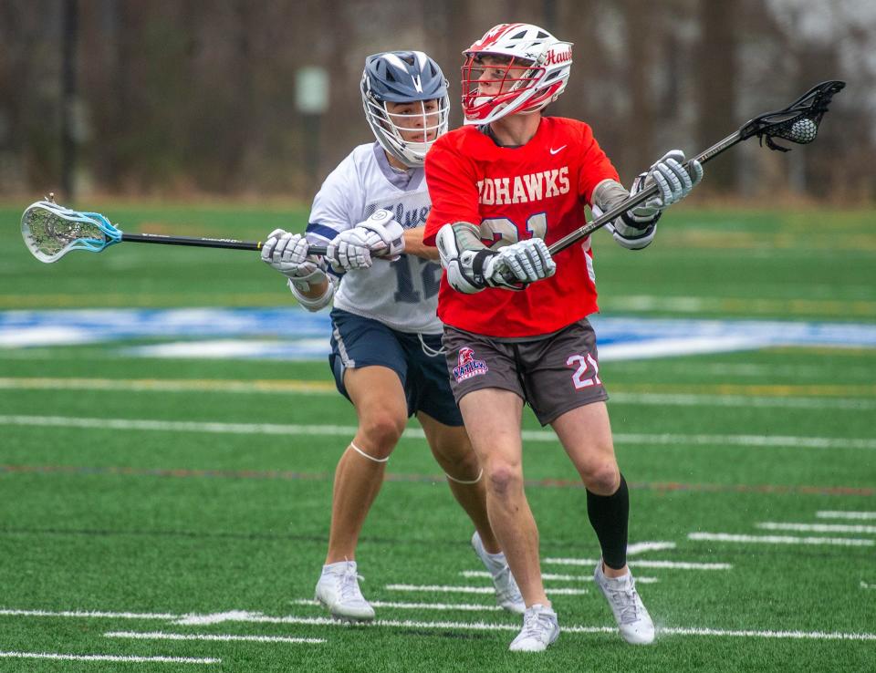 Natick High School sophomore Levi Gagnon, defended by Framingham senior Noah Albright at Fuller Field, April 11, 2024.