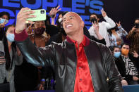 <p>Dwayne "The Rock" Johnson obliges some lucky fans with a photo on the red carpet at the 2021 People's Choice Awards in Santa Monica, California, on Dec. 7.</p>