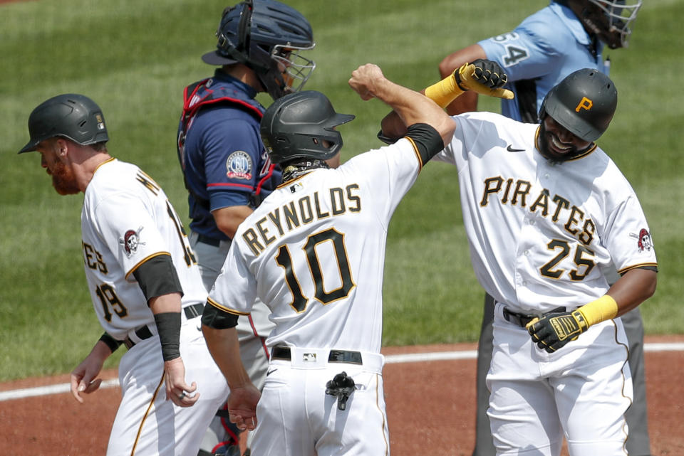 Pittsburgh Pirates' Gregory Polanco (25) celebrates with Bryan Reynolds (10) and Colin Moran (19) after Polanco hit a home run scoring them in the second inning of a baseball game against the Minnesota Twins, Thursday, Aug. 6, 2020, in Pittsburgh. Minnesota Twins catcher Alex Avila, is at top center. (AP Photo/Keith Srakocic)