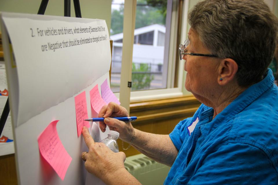 Shirley Lange writes her thoughts on a sticky note during a public meeting to discuss the future of Swansea Mall Drive held at the Swansea Council on Aging on Tuesday, June 6, 2023.