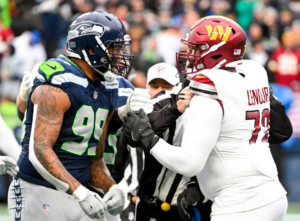 Seattle Seahawks defensive end Leonard Williams (99) and Washington Commanders offensive tackle Charles Leno Jr. (72) chirp at one another before officials intervened during the second quarter of the game at Lumen Field, on Sunday, Nov. 12, 2023, in Seattle.