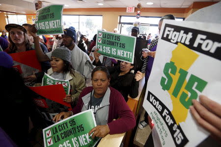 Fast-food workers and their supporters join a nationwide protest for higher wages and union rights inside McDonald's in Los Angeles, California, United States, November 10, 2015. REUTERS/Lucy Nicholson