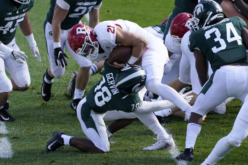 Michigan State cornerback Kalon Gervin (18) tackles Rutgers quarterback Johnny Langan after he crosses the goal line for a 1-yard touchdown during the first half of an NCAA college football game, Saturday, Oct. 24, 2020, in East Lansing, Mich. (AP Photo/Carlos Osorio)