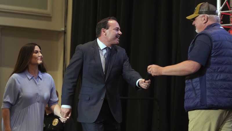 U.S. Sen. Mike Lee, center, of Utah, and his wife, Sharon Lee, left, greet radio talk-show host Glenn Beck as he walks on stage during a Utah Republican election night party, Tuesday, June 28, 2022, in South Jordan, Utah.