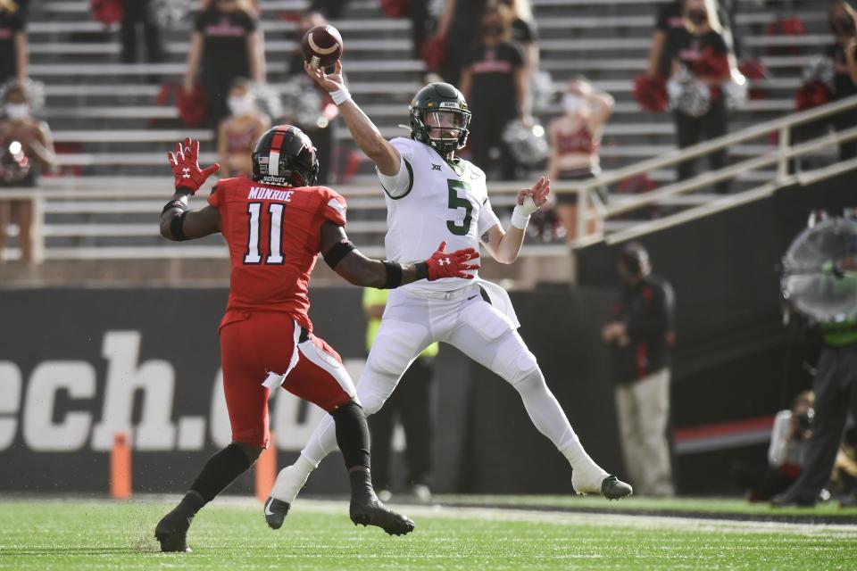 Baylor quarterback Charlie Brewer (5) throws under pressure from Texas Tech defensive back Eric Monroe (11) at an NCAA college football game in Lubbock, Texas, Saturday, Nov. 14, 2020. (AP Photo/Justin Rex)