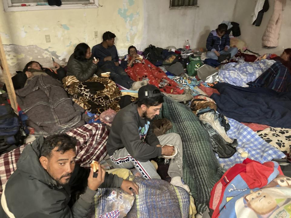 Migrants seek refuge from winter weather in a crowded shelter near the U.S. border with Mexico in Ciudad Juárez, Mexico, on Thursday, Dec. 22, 2022. Hundreds of migrants are gathered in unusually frigid cold temperatures along the Mexican-U.S. border near El Paso, Texas, awaiting a U.S. Supreme Court decision on whether and when to lift pandemic-era restrictions that prevent many from seeking asylum. (AP Photo/Morgan Lee)
