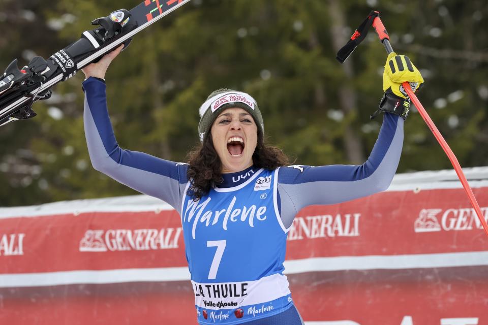 FILE -- In this Feb. 29, 2020 file photo, Italy's Federica Brignone celebrates taking second place in an alpine ski, women's World Cup Super G, in La Thuile, Italy. Amid a worldwide suspension of sports events, Brignone was awaiting a special delivery which arrived last month, with three crystal globes: the big 9-kilogram (20-pound) prize for her first overall World Cup triumph — she’s the first Italian woman to win the coveted honor in the 53-year history of the competition -- plus two smaller 3.5-kilogram (8-pound) globes for her season-long giant slalom and Alpine combined titles. (AP Photo/Alessandro Trovati)