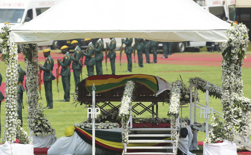 The casket carrying the remains of the former president Robert Mugabe displayed on a a podium at the National Sports stadium during a funeral procession in Harare, Saturday, Sept, 14, 2019. African heads of state and envoys are gathering to attend a state funeral for Mugabe, whose burial has been delayed for at least a month until a special mausoleum can be built for his remains. (AP Photo/Tsvangirayi Mukwazhi)