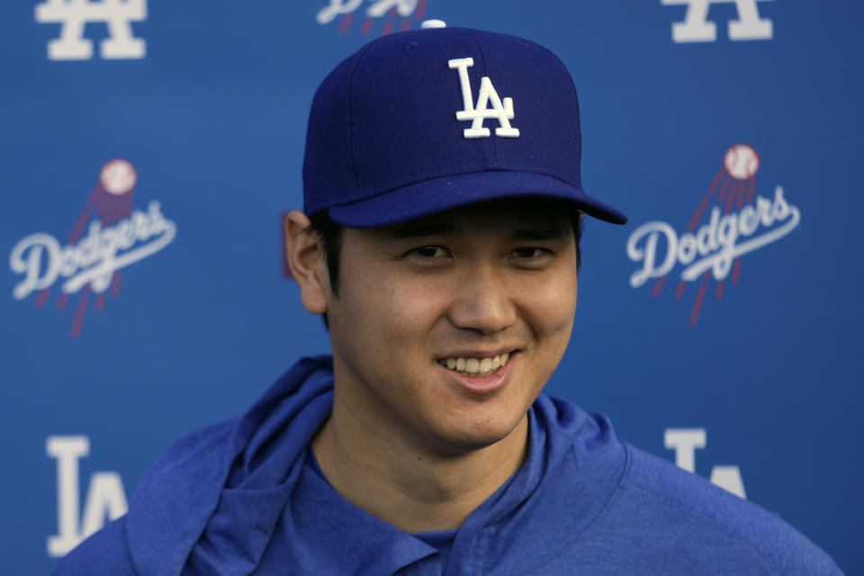 FILE - Los Angeles Dodgers' Shohei Ohtani smiles as he speaks to media at Camelback Ranch in Phoenix, Friday, Feb. 9, 2024, the first day of spring training baseball workouts for the Dodgers. Ohtani had his right elbow repaired by Dr. Neal ElAttrache for the second time in September. With the 50th anniversary of the first Tommy John surgery coming up this year, Ohtani and ElAttrache are at the center of what might be the procedure’s most compelling case study. (AP Photo/Carolyn Kaster, File)