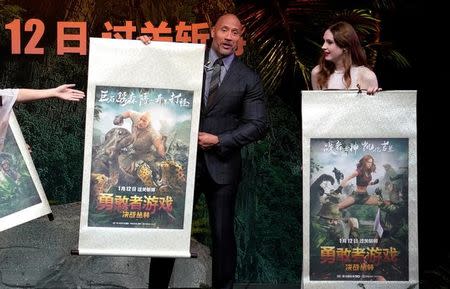 Cast members Dwayne Johnson (L) and Karen Gillan attend a news conference promoting their film "Jumanji: Welcome to the Jungle" in Beijing, China, January 4, 2018. REUTERS/Jason Lee