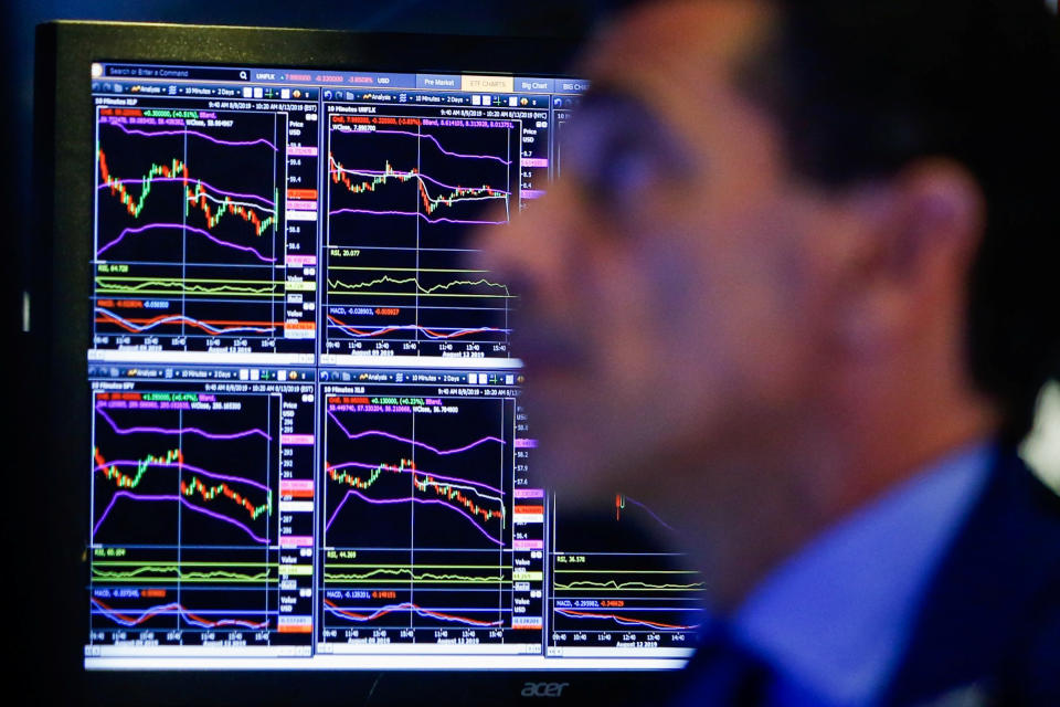 A trader looks at screens as he works on the floor at the New York Stock Exchange (NYSE) in New York, U.S., August 13, 2019. REUTERS/Eduardo Munoz - RC1C0EF05090