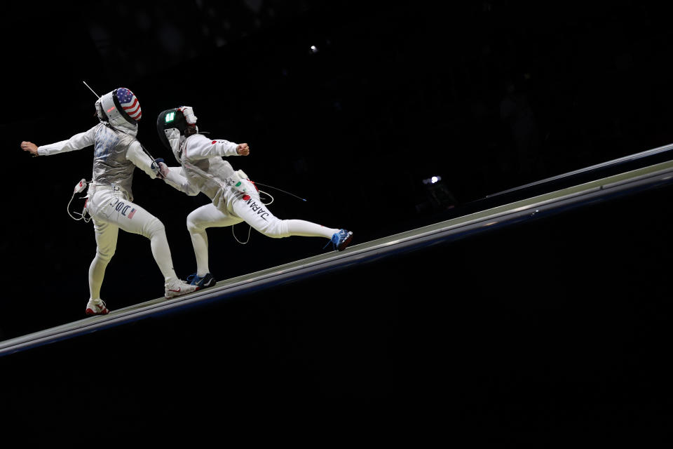 <p>Lee Kiefer of Team United States, left, competes against Rio Azuma of Team Japan in Women's Foil Team Quarterfinal on day six of the Tokyo 2020 Olympic Games at Makuhari Messe Hall on July 29, 2021 in Chiba, Japan. (Photo by Elsa/Getty Images)</p> 