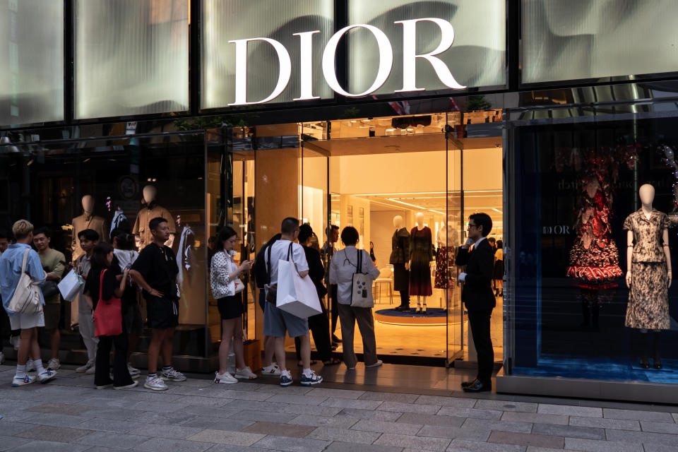 Chinese tourists wait in line outside a Dior store in the Ginza district in Tokyo, Japan. 