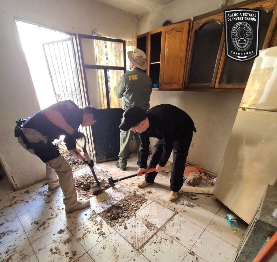 Chihuahua state investigators remove a floor during a search on Tuesday that found three bodies buried underneath a floor in a house on Hospital Street in Barrio Alto near downtown Juárez, Mexico.