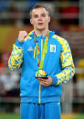 <p>Gold medalist Oleg Verniaiev of Ukraine poses for photographs at the medal ceremony for the Parallel Bars on Day 11 of the Rio 2016 Olympic Games at the Rio Olympic Arena on August 16, 2016 in Rio de Janeiro, Brazil. (Photo by Alex Livesey/Getty Images) </p>