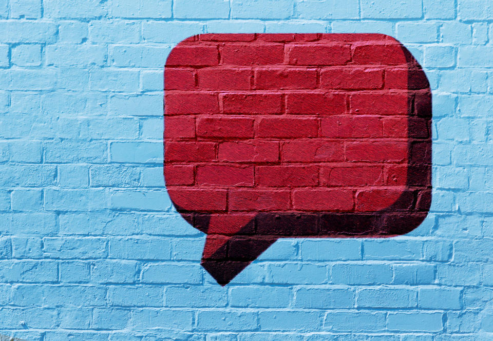 Speech bubble graffiti on a brick wall