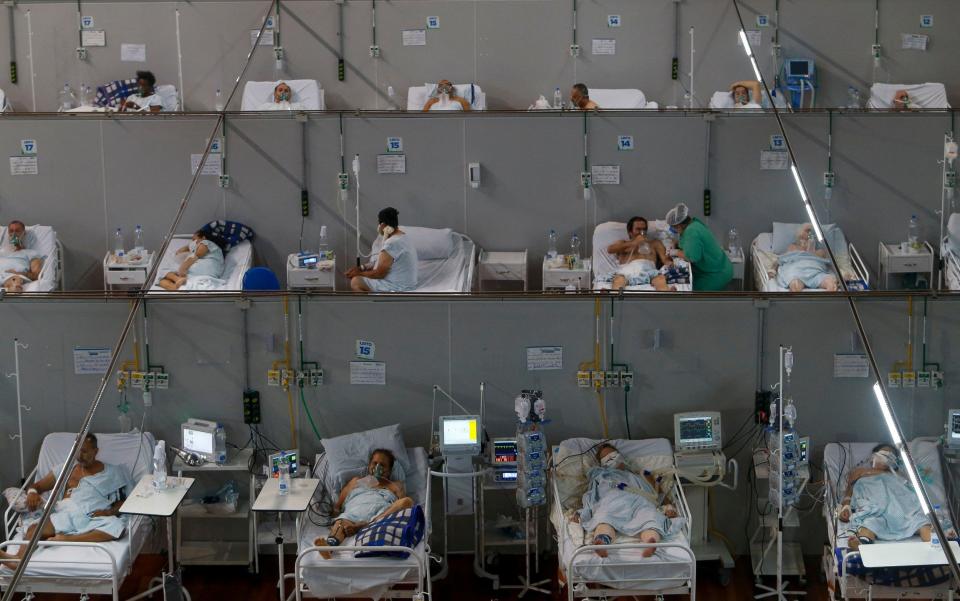 Patients affected by the COVID-19 coronavirus remain at a field hospital set up at a sports gym, in Santo Andre, Sao Paulo state, Brazil - MIGUEL SCHINCARIOL/AFP