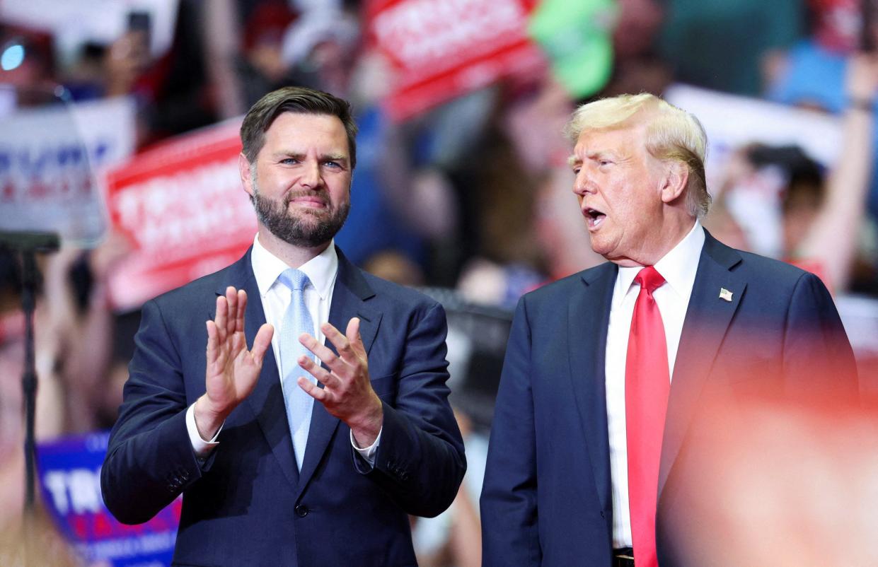 Republican presidential nominee and former U.S. President Donald Trump stands with Republican vice presidential nominee U.S. Sen. JD Vance, R-Ohio, as he holds a rally for the first time with his running mate in Grand Rapids, Michigan.
