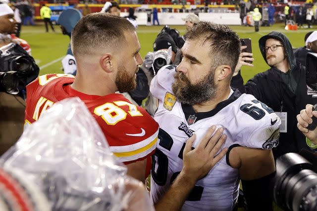 <p>David Eulitt/Getty</p> Jason Kelce #62 of the Philadelphia Eagles talks to brother Travis Kelce #87 of the Kansas City Chiefs, 2023