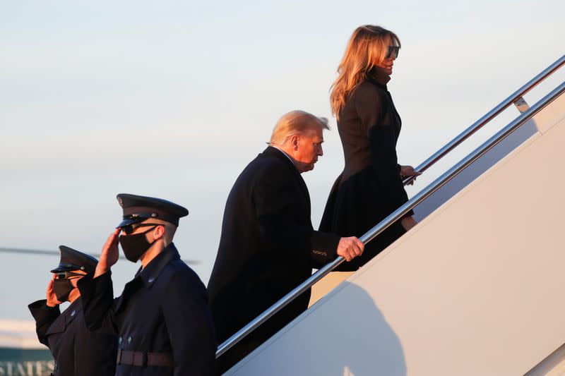 U.S. President Donald Trump boards Air Force One beside first lady Melania Trump at Joint Base Andrews in Maryland