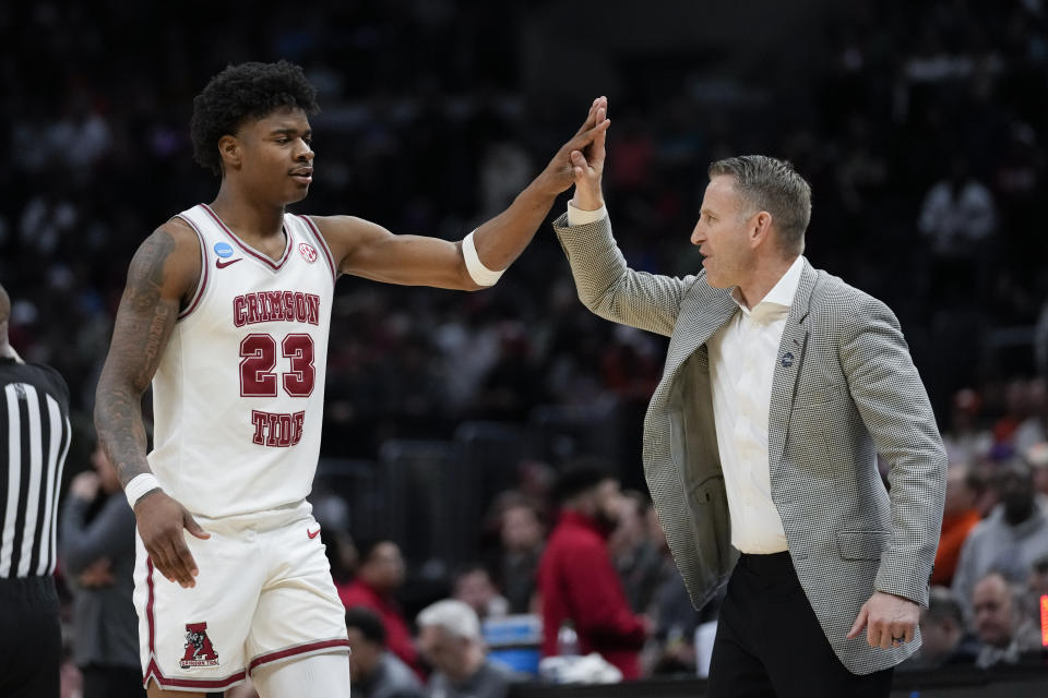 Alabama forward Nick Pringle (23) is high-fived by head coach Nate Oats during the second half of an Elite 8 college basketball game against Clemson in the NCAA tournament Saturday, March 30, 2024, in Los Angeles. (AP Photo/Ashley Landis)