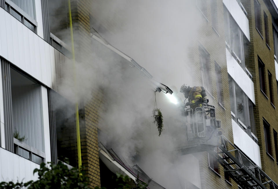 Smoke billows from an apartment building after an explosion in Annedal, central Gothenburg, Sweden, Tuesday Sept. 28, 2021. The explosion took place in the early hours of the morning, and rescue services are still working to extinguish fires that spread to several apartments. (Bjorn Larsson Rosvall/TT via AP)