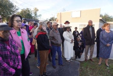 Family, friends and community members gathered across the street of Chestnut Funeral Home on Tuesday to witness the unveiling of the street sign named after the late Charles S. Chestnut III.
(Credit: Photo by Voleer Thomas, Correspondent)