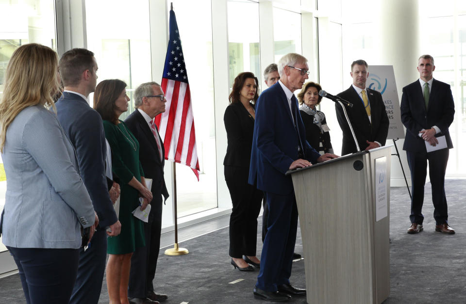 Wisconsin Gov. Tony Evers, center, is joined other governors and premiers during a press conference at the 2019 Leadership Summit at the Discovery World, Friday, June 14, 2019, in Milwaukee, Wis.. Evers along with other governors and premiers are in town to discuss a series of actions on water, transportation, impact investing and tourism as related to the Great Lakes and Saint Lawrence River. (Angela Peterson/Milwaukee Journal-Sentinel via AP)