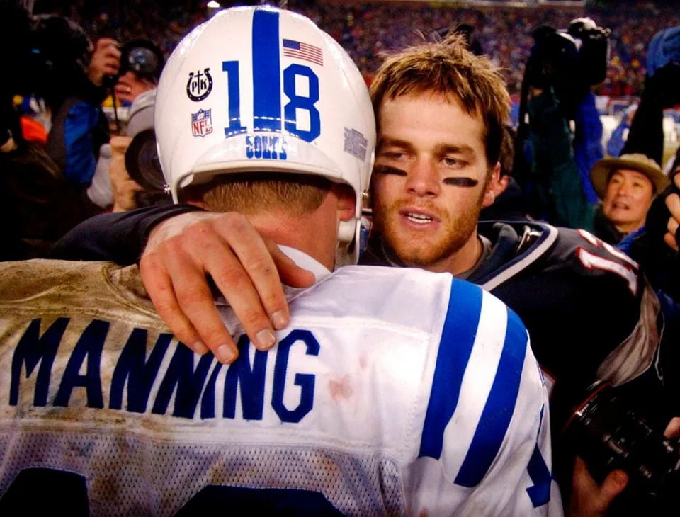 FILE - In this Jan. 18, 2004, file photo, New England Patriots quarterback Tom Brady, right, talks with Indianapolis Colts quarterback Peyton Manning after the Patriots 24-14 win during their AFC Championship game in Foxborough, Mass. The rivalry that defined much of Brady's career was the one he had with Manning. Brady won 11 of the 17 meetings, including the first time they met in the playoffs. (AP Photo/Charles Krupa, File)