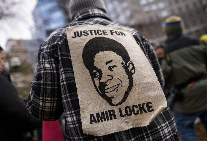 A person wears a portrait of Amir Locke outside the Hennepin County Government Center on April 6, 2022 in Minneapolis, Minnesota. (Photo by Stephen Maturen/Getty Images)