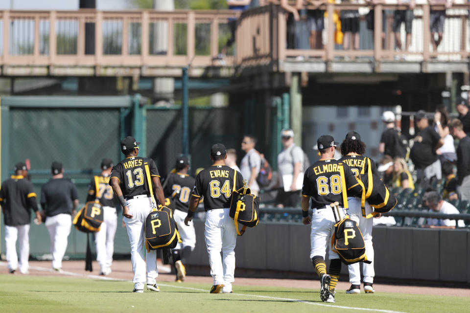 Members of the Pittsburgh Pirates leave the field after a spring training baseball game against the Toronto Blue Jays, Thursday, March 12, 2020, in Bradenton, Fla. (AP Photo/Carlos Osorio)