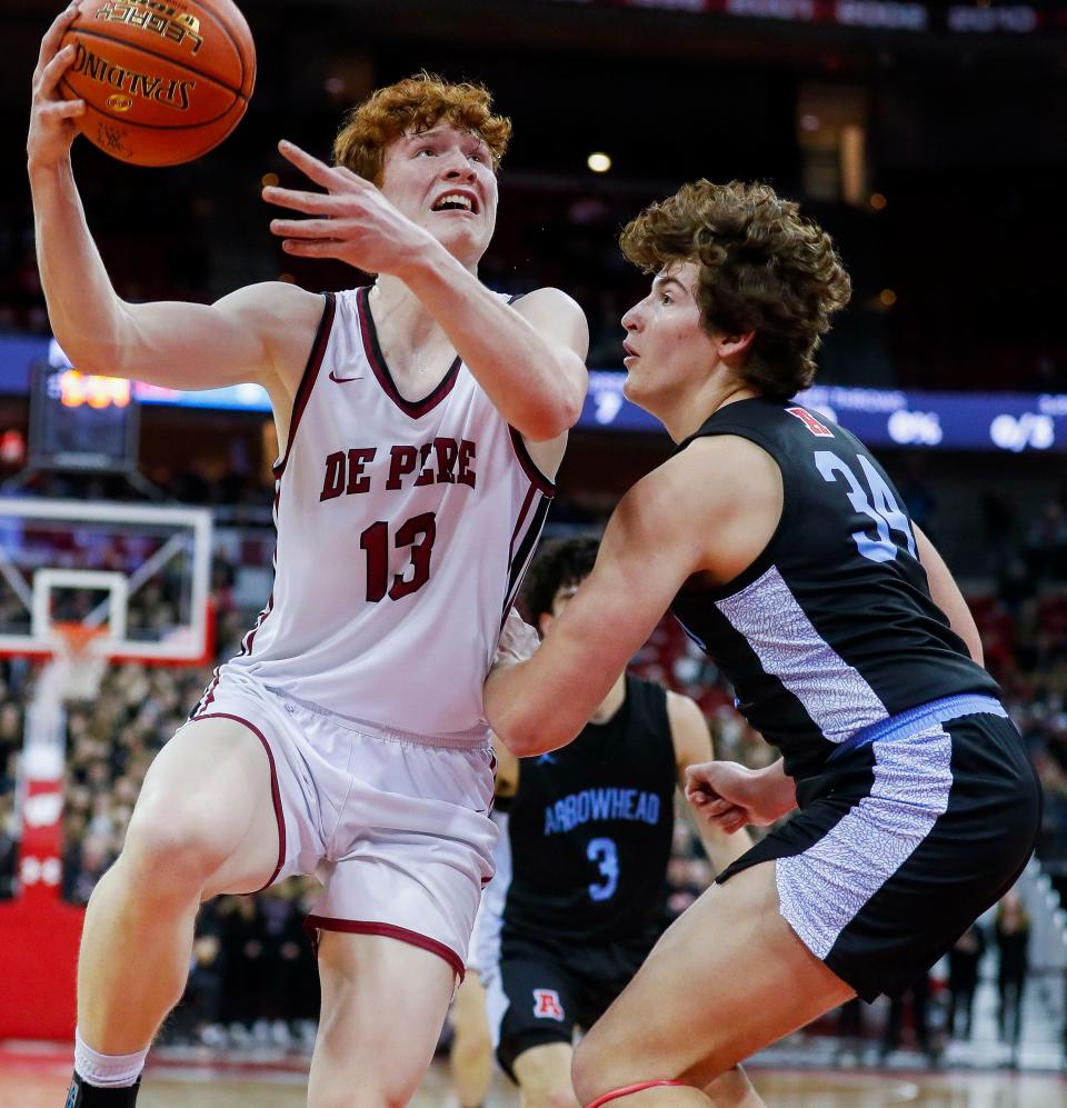 De Pere's Will Hornseth (13) goes up for a shot against Arrowhead during the WIAA Division 1 boys basketball state championship game Saturday at the Kohl Center in Madison.
