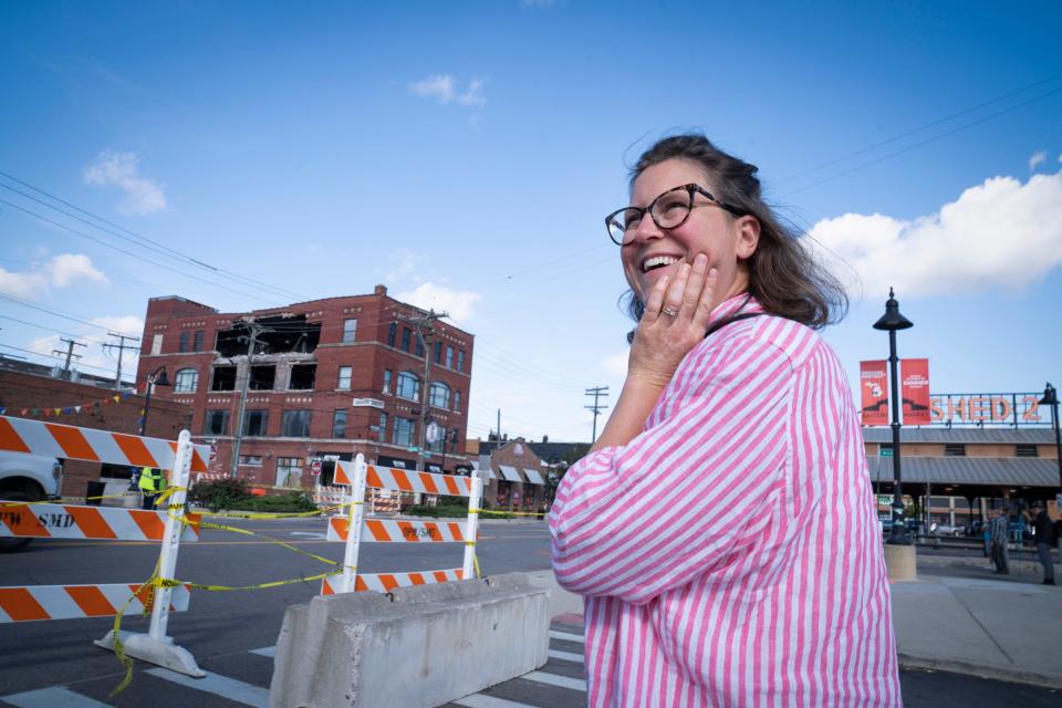 Lindsay Studders, 37, of Grosse Pointe Park looks on Tuesday, Sept. 19, 2023, at the building that partially collapsed in Eastern Market on Saturday, Sept. 16, 2023, as she and a friend were coming down to shop during Tuesday market day.