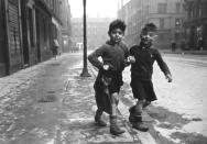 Two boys walk arm-in-arm in 'Gorbals Boys, Glasgow, Europe’s worst slum,' 1948 (Bert Hardy/ Getty Images)