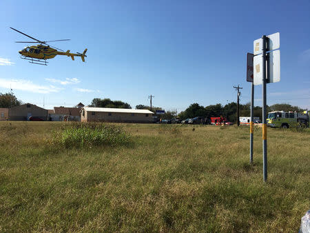 A helicopter flies near the site of a mass shooting in Sutherland Springs, Texas, U.S., November 5, 2017, in this picture obtained via social media. MAX MASSEY/ KSAT 12/via REUTERS