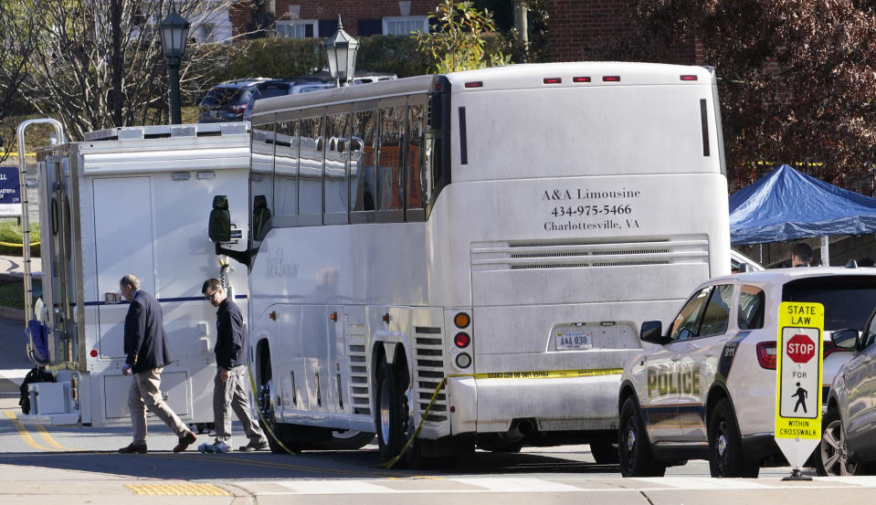 Police investigators work around a bus which is believed to be the site of an overnight shooting on the grounds of the University of Virginia Monday, Nov. 14, 2022, in Charlottesville. Va. Authorities say three people have been killed and two others were wounded in a shooting at the University of Virginia and a student suspect is in custody. (AP Photo/Steve Helber)