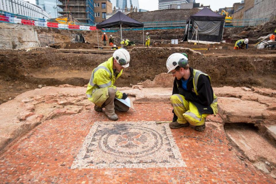 Archaeologists document the more recent, upper mosaic.