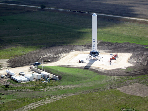 Grasshopper consists of a Falcon 9 rocket first stage, Merlin 1D engine, four steel landing legs with hydraulic dampers, and a steel support structure. For a sense of its scale, note the blue pick-up truck to the left of Grasshopper in the phot