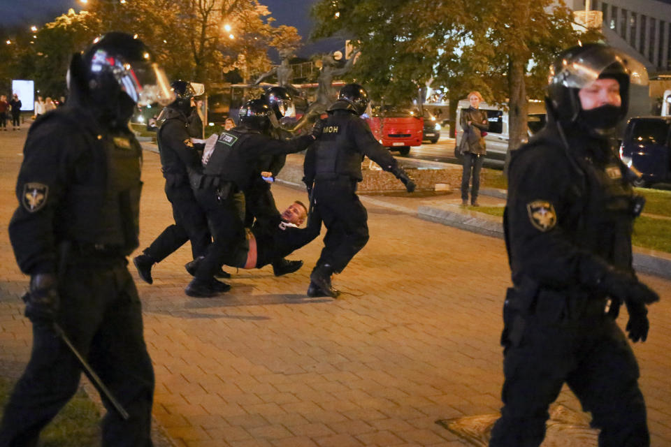 Riot police detain a protester during an opposition rally to protest the presidential inauguration in Minsk, Belarus, Wednesday, Sept. 23, 2020. Belarus President Alexander Lukashenko has been sworn in to his sixth term in office at an inaugural ceremony that was not announced in advance amid weeks of huge protests saying the authoritarian leader's reelection was rigged. Hundreds took to the streets in several cities in the evening to protest the inauguration. (AP Photo/TUT.by)