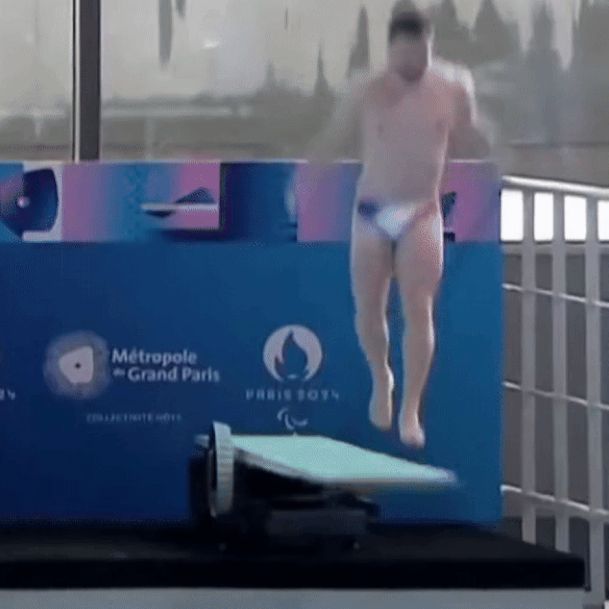 French diver Alexis Jandard falls onto the board during a demonstration at the the Olympic Aquatics Centre in Saint-Denis, north of Paris on April 4, 2024.  (Metropole Du Grand Paris / AFP - Getty Images)